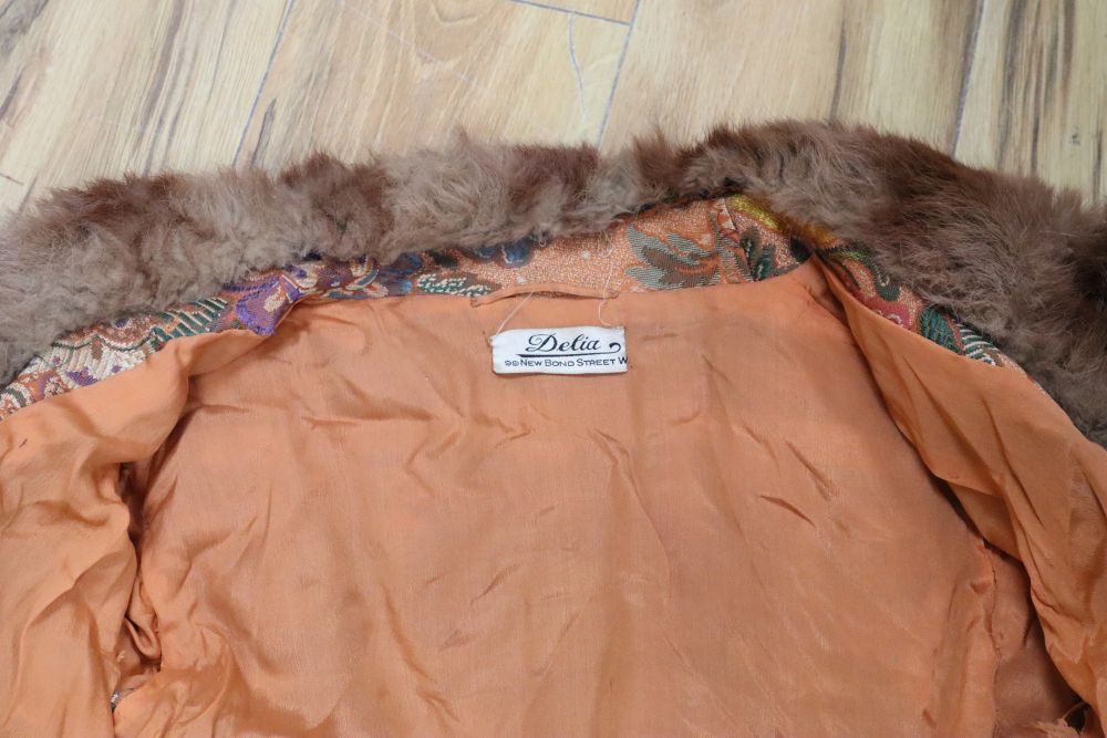 A 1930s orange brocade floral fur trimmed coat label Delia, 99 New Bond Street